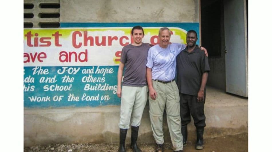 NHSI co-founder with Noe Jilles and community leaders outside the church and school in Laguille