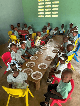 Students sharing a daily meal at their school desks